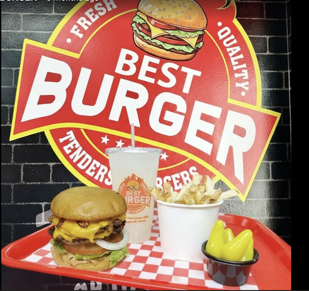 A Best Burger combo and drink on a red tray in front of the big Best Burger wall logo.